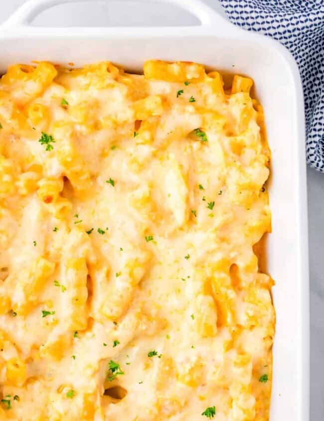 Cheesy macaroni and cheese baked in a white dish.