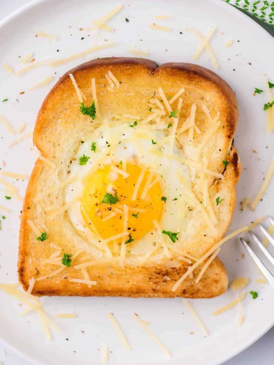 A classic breakfast dish featuring a fried egg nestled within a slice of toast.