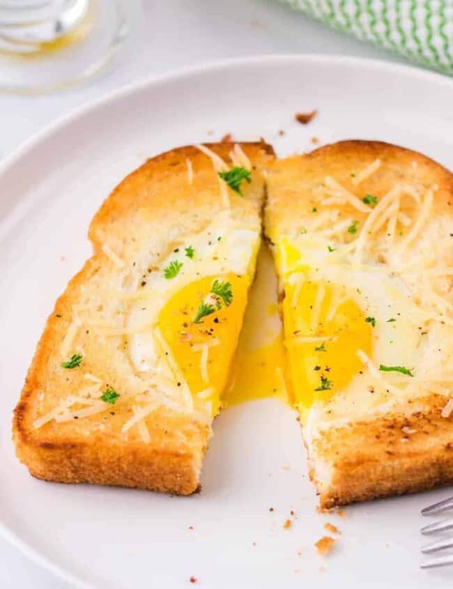 egg in a hole cut in half on a plate