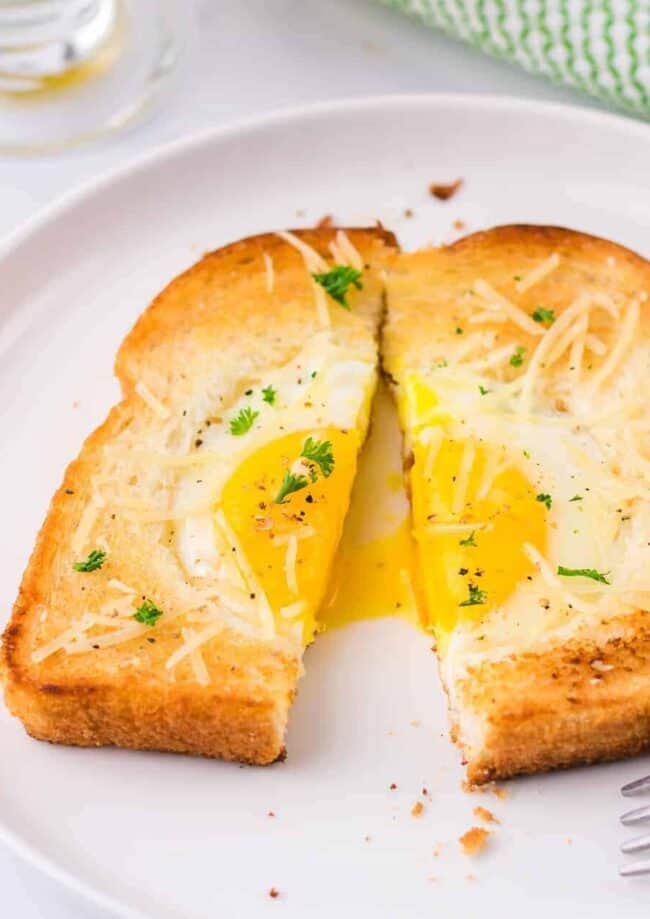 egg in a hole cut in half on a plate