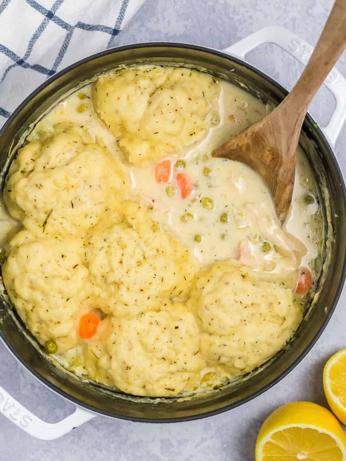 A wooden spoon in the chicken and dumplings