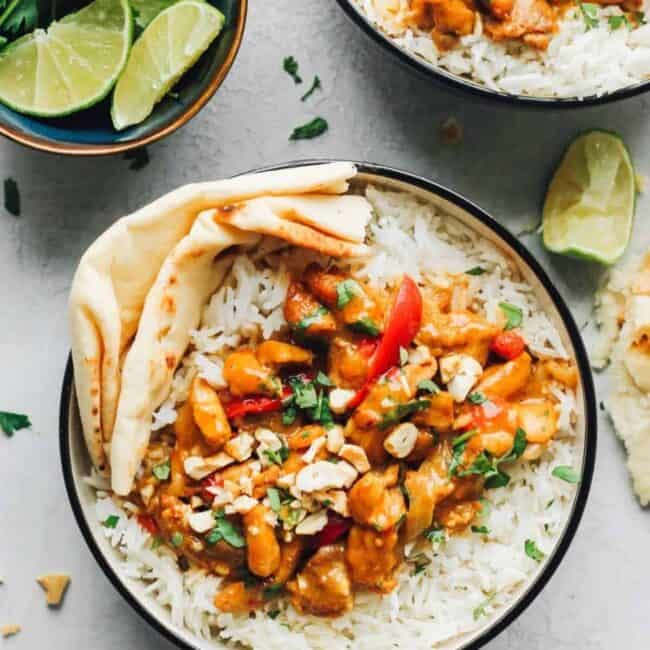 An easy chicken curry dish featuring tender chicken tikka masala served with rice and lime wedges.