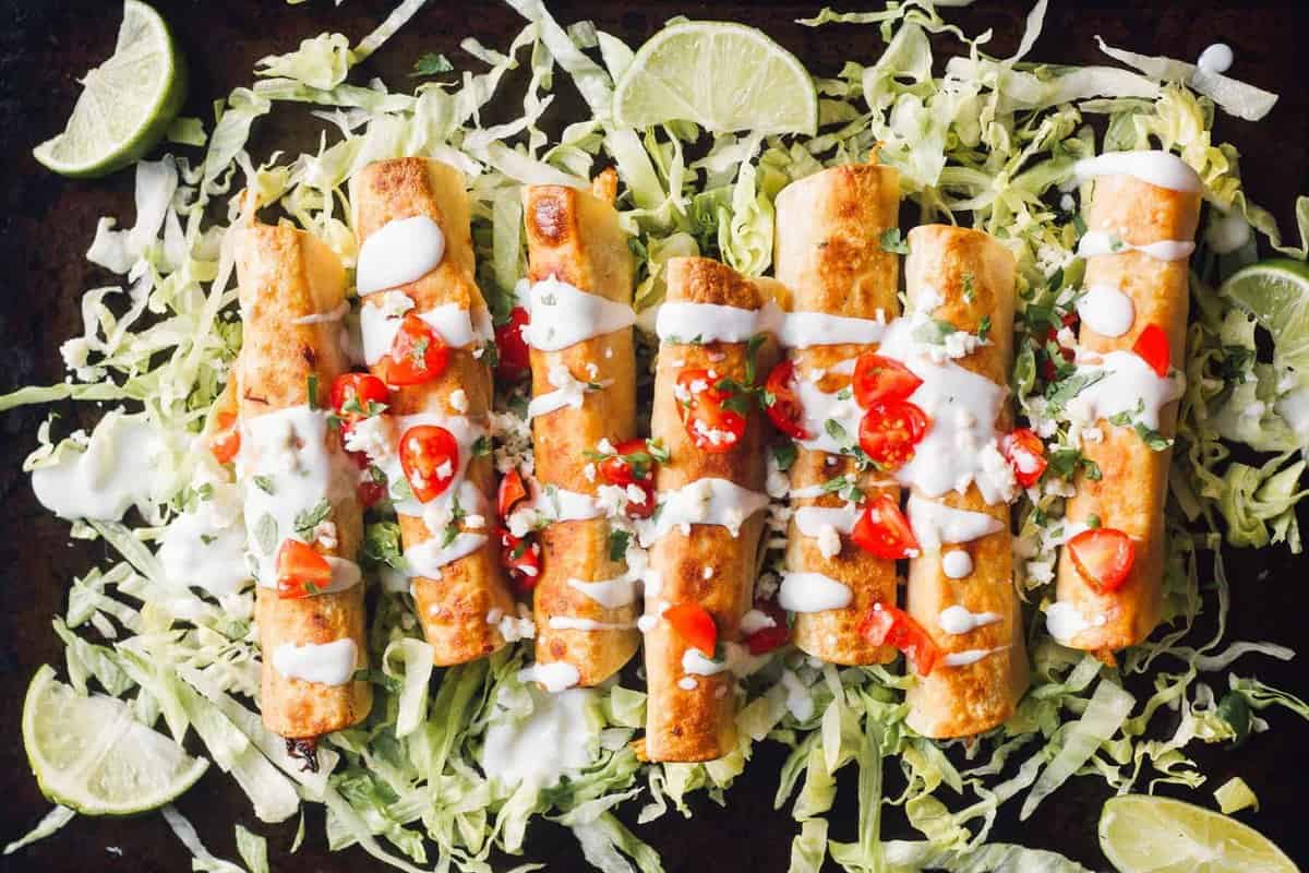 fried chicken flautas on bed of lettuce