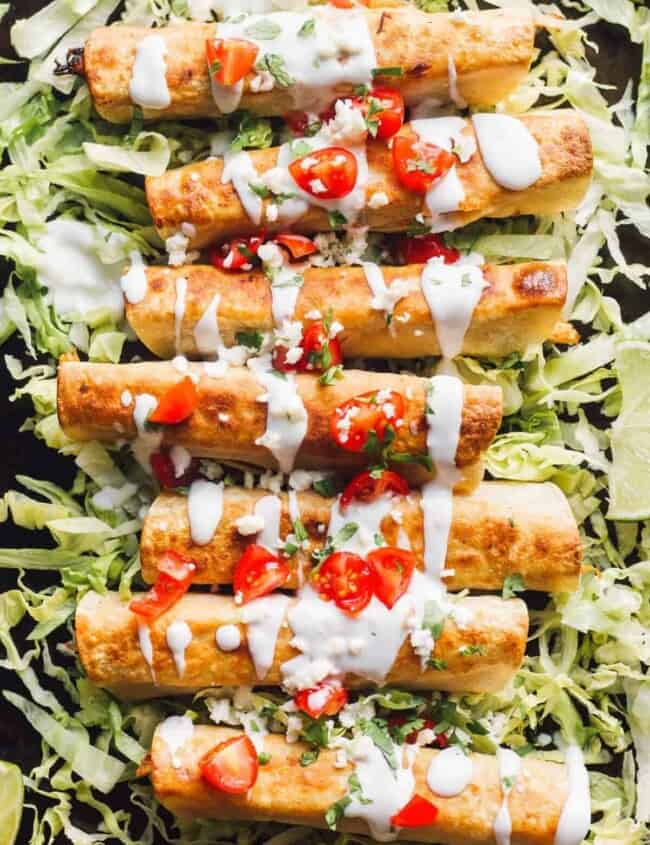 fried chicken flautas on lettuce