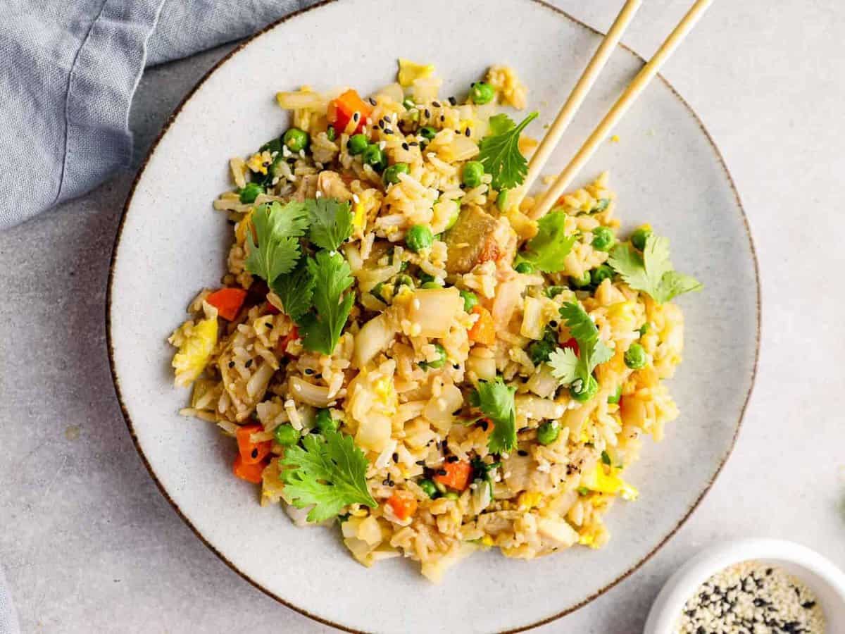 plate of chicken fried rice with chopsticks