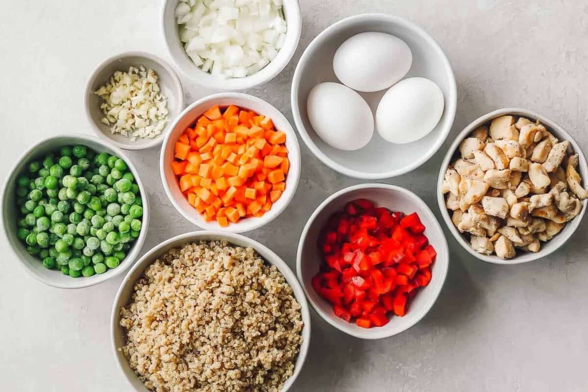 Quinoa Fried Rice is a healthy version of the take-out favorite and an easy one pan dish that’s perfect for those busy weeknights. This Quinoa Fried Rice Recipe is chocked full of veggies and chicken; making it a wholesome, filling meal the whole family will love!