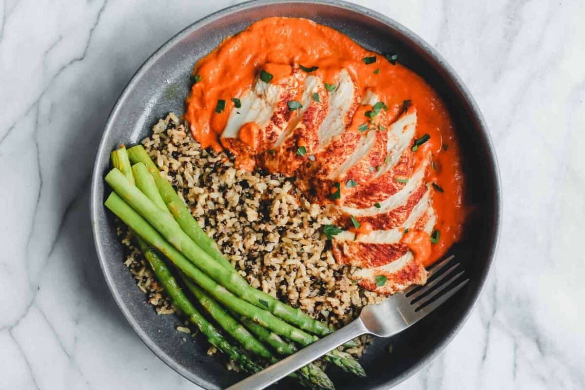 a plate with rice, asparagus, and romesco sauce.