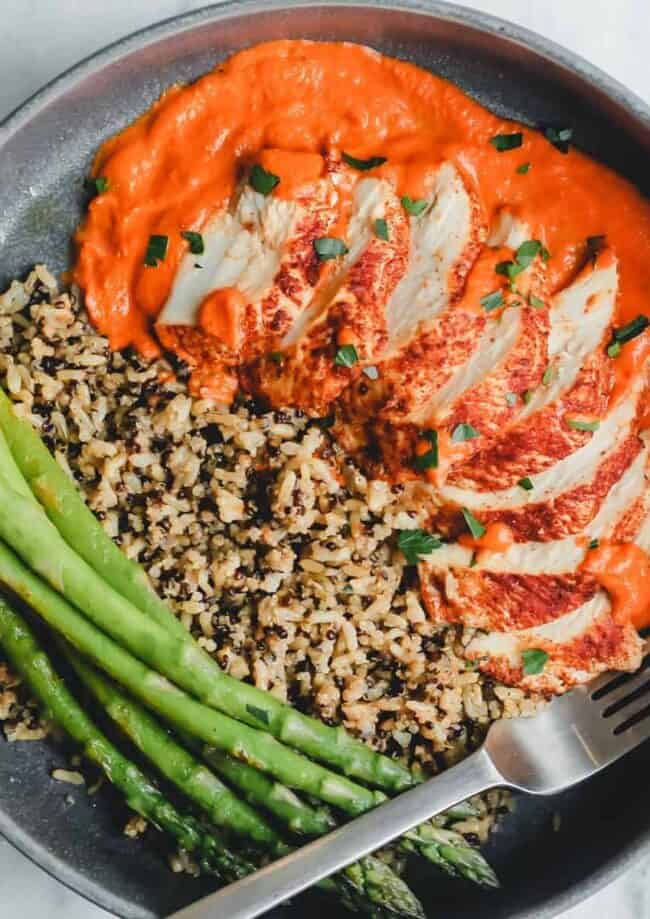 a plate with rice, asparagus, and romesco sauce.