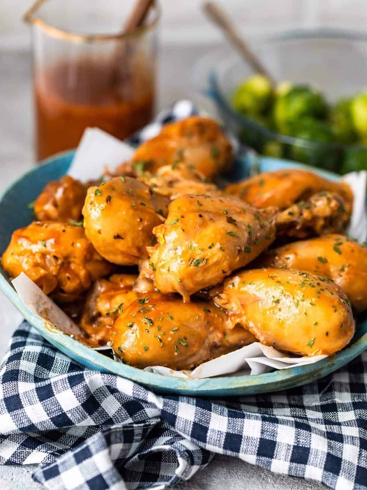 a plate of slow cooker BBQ chicken drumsticks 