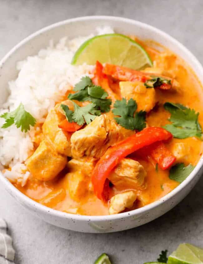 side image of thai red curry chicken in bowl with rice