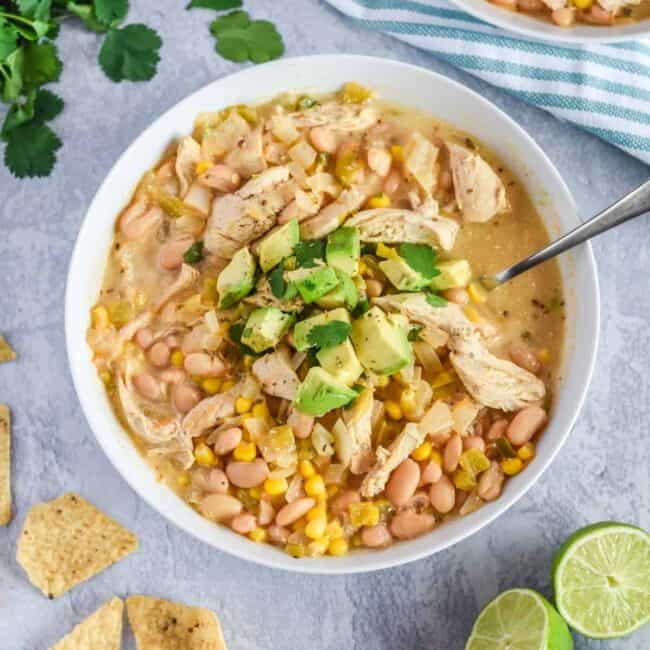white chicken chili in bowl garnished with avocado