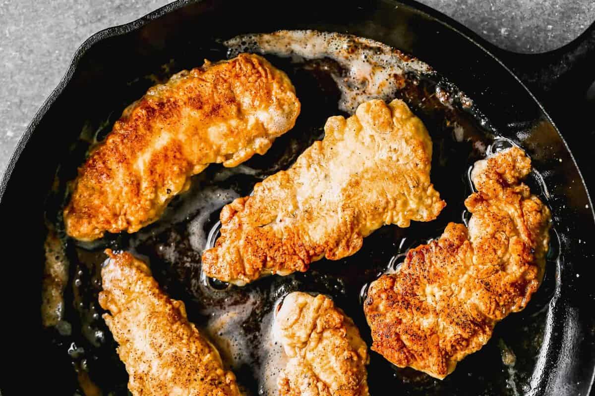 frying chicken in skillet