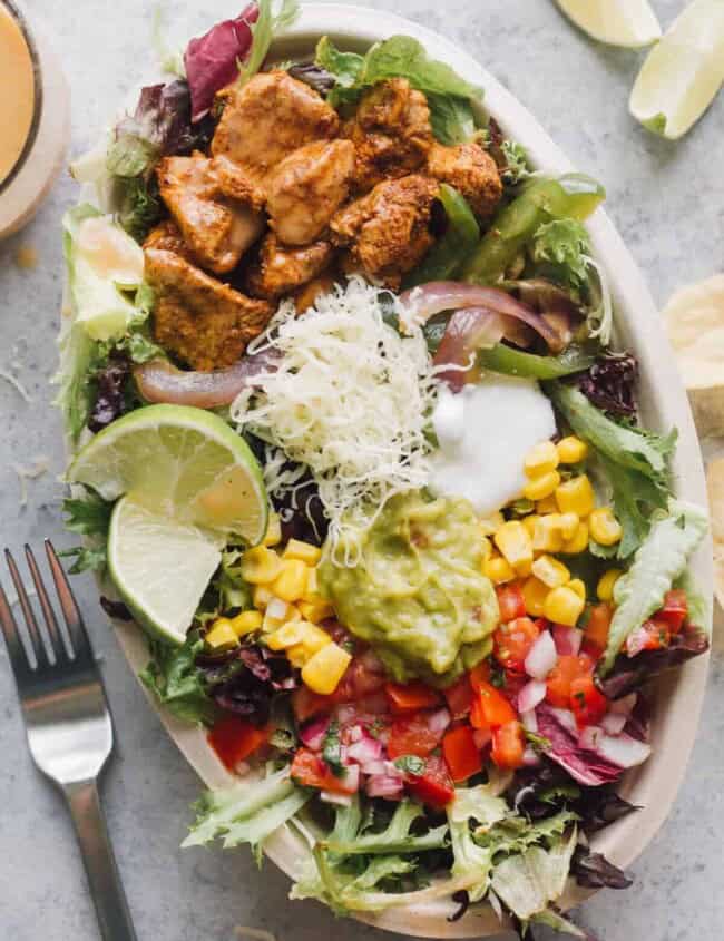 chipotle mexican chicken salad with toppings in bowl