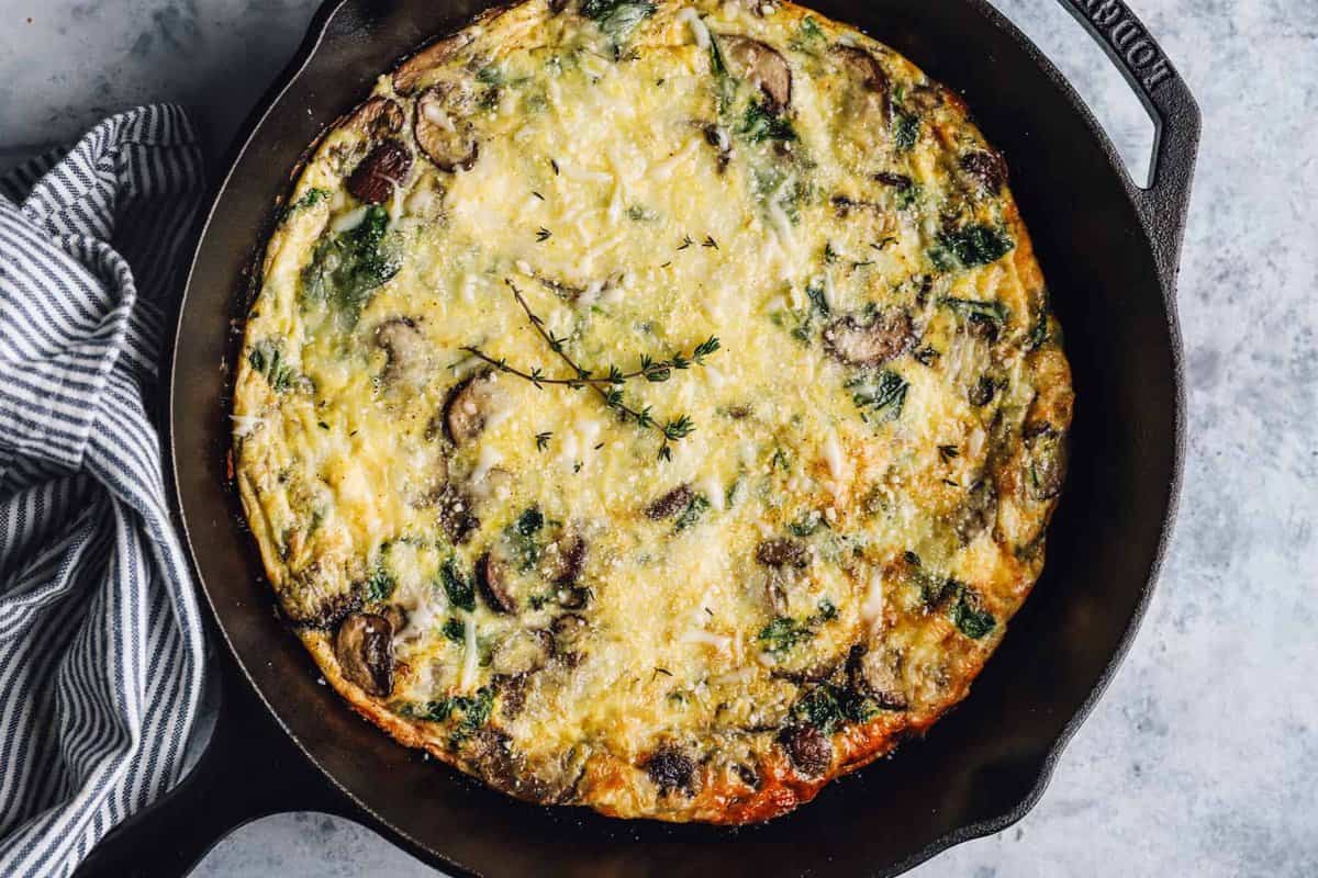 mushroom and spinach frittata in a cast iron skillet