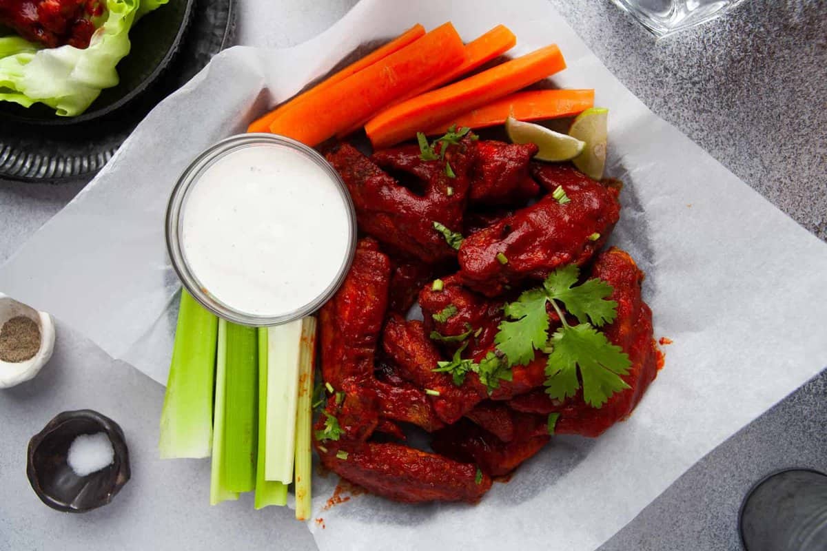 air fryer hot honey chicken wings with carrots and celery and ranch.