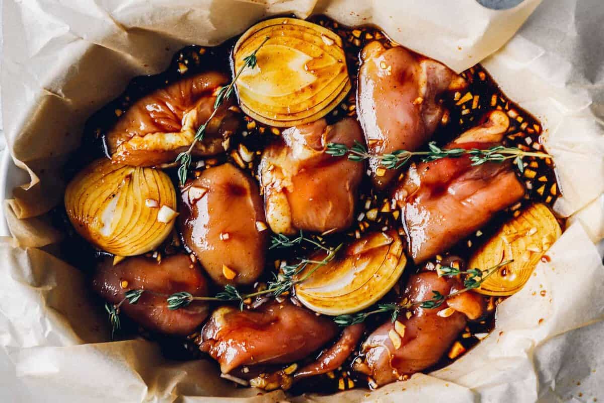 a baking dish filled with chicken thighs in a honey balsamic glaze