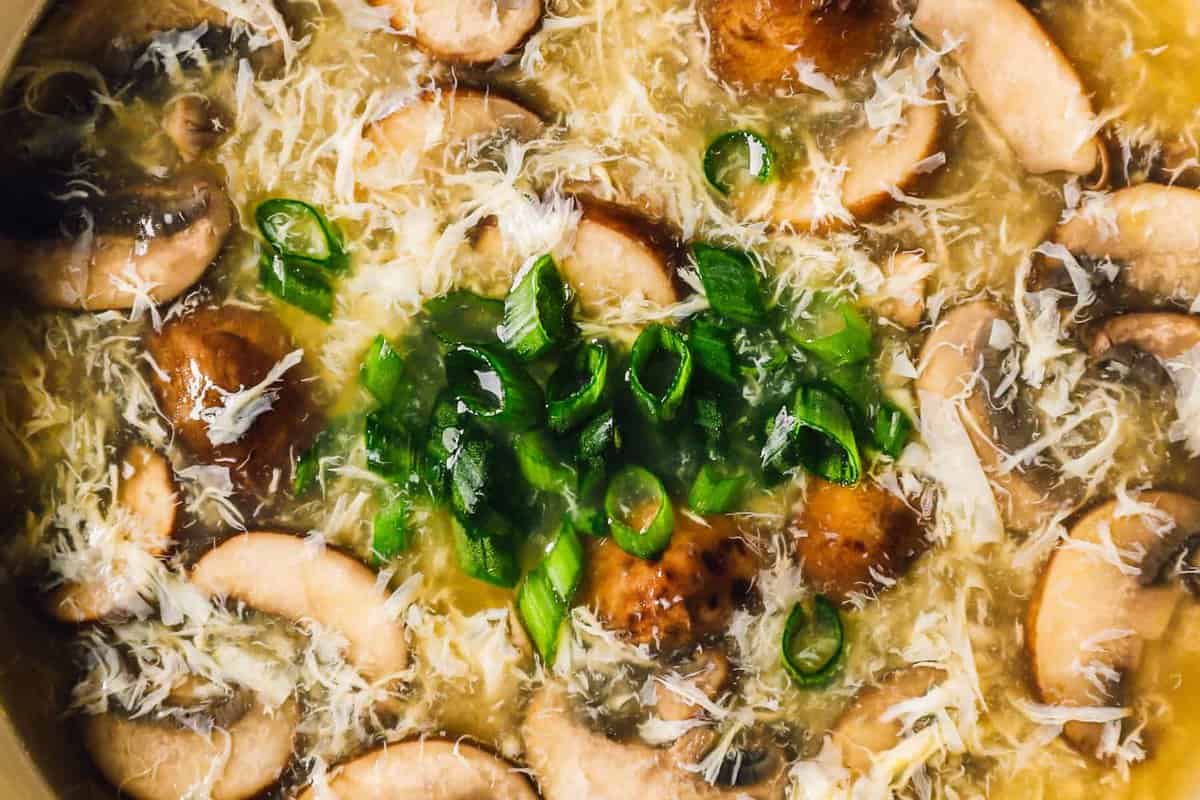 close up on a bowl of egg drop soup with mushrooms
