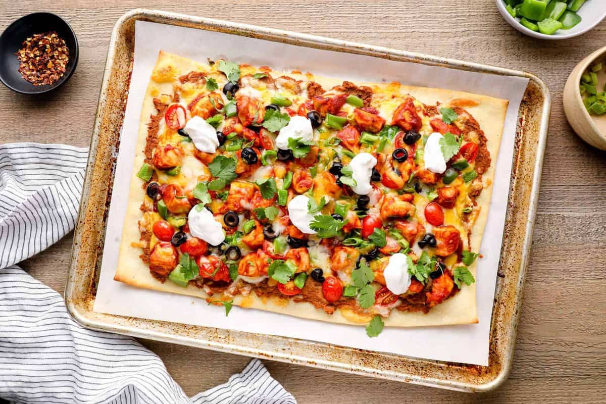 chicken taco pizza on a baking sheet