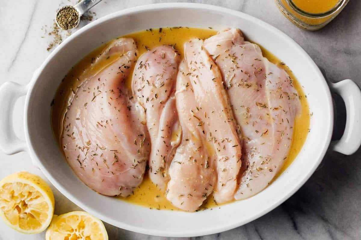 chicken breasts in baking dish with lemon sauce