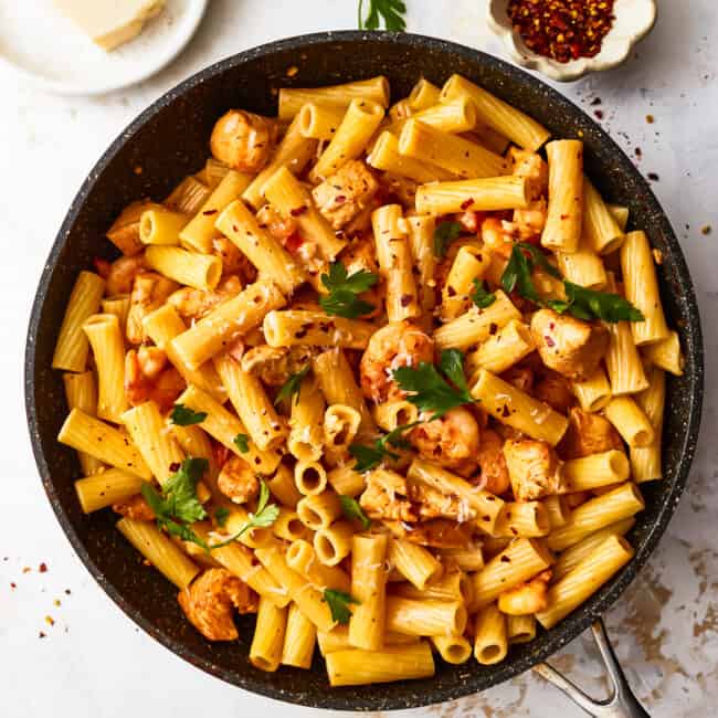 overhead view of cajun chicken pasta in a frying pan.