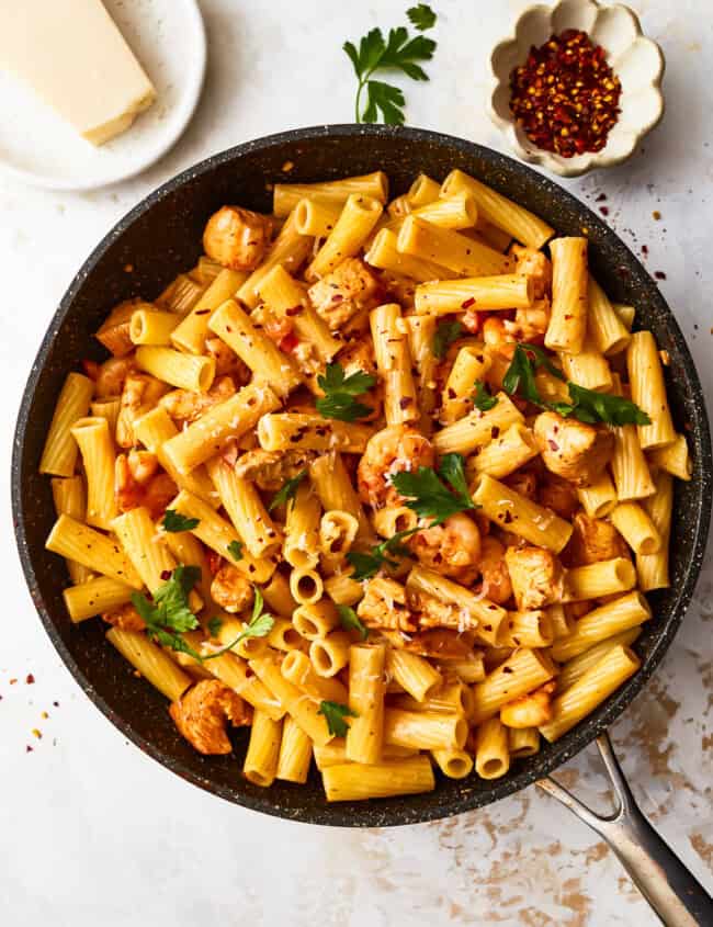 overhead view of cajun chicken pasta in a frying pan.