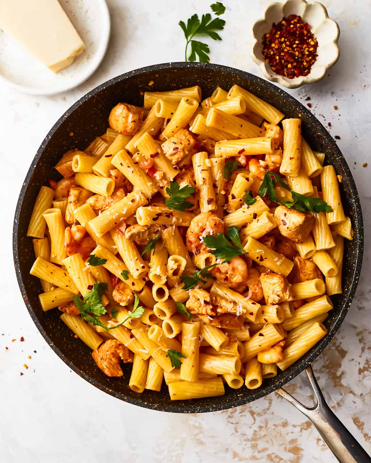 overhead view of cajun chicken pasta in a frying pan.