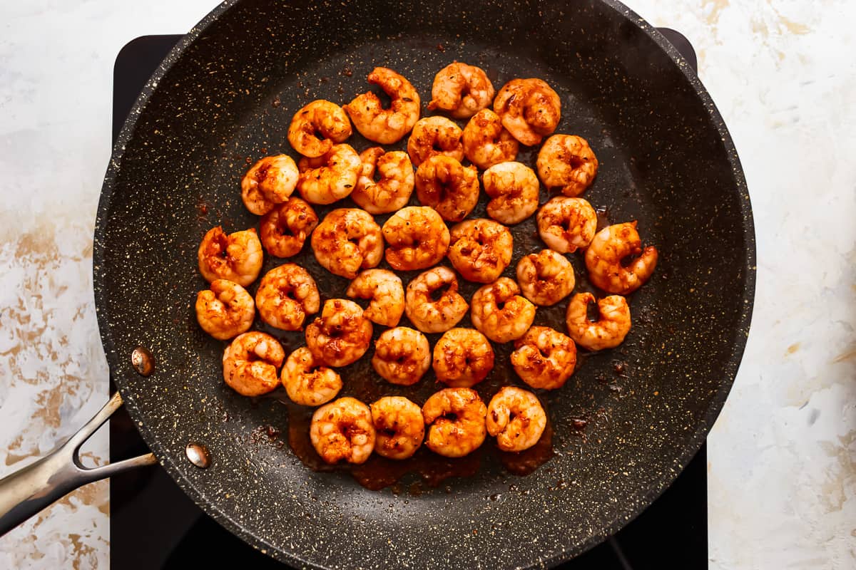 seasoned shrimp in a frying pan.