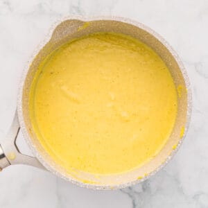 creamy yellow sauce in a saucepan.