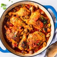 overhead view of chicken marengo in a blue pan.