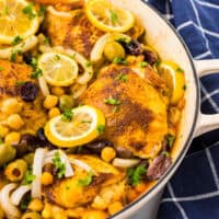 partial view of moroccan chicken thighs in a pot.