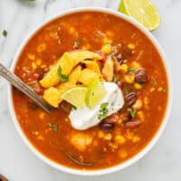 overhead view of southwest chicken soup in a bowl with a spoon.