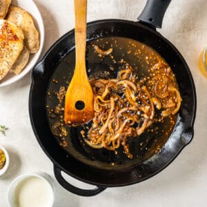 deglazing a pan of onions with white wine.
