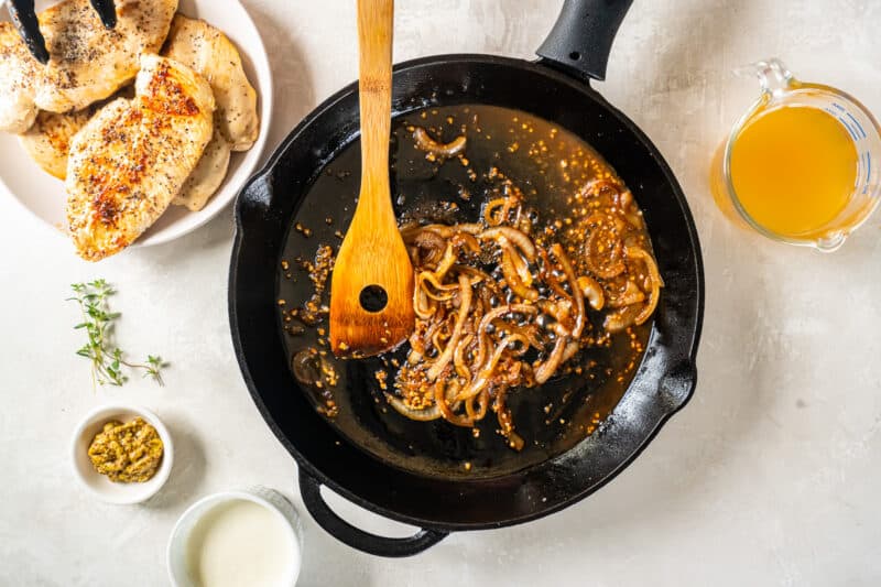 deglazing a pan of onions with white wine.