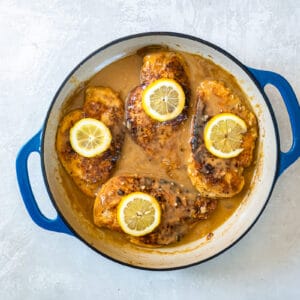 overhead view of chicken francese in a pan.