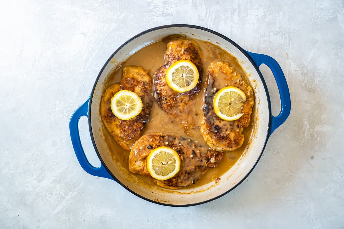 overhead view of chicken francese in a pan.