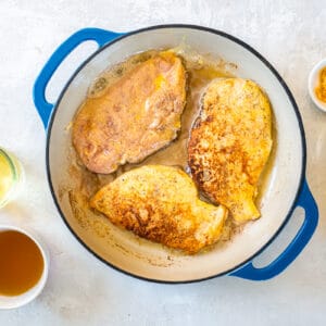 seared chicken breasts in a pan.