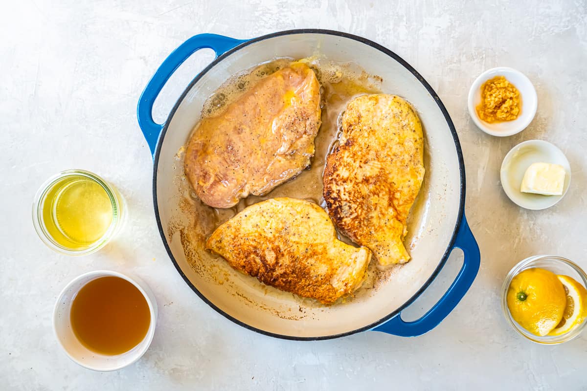 seared chicken breasts in a pan.