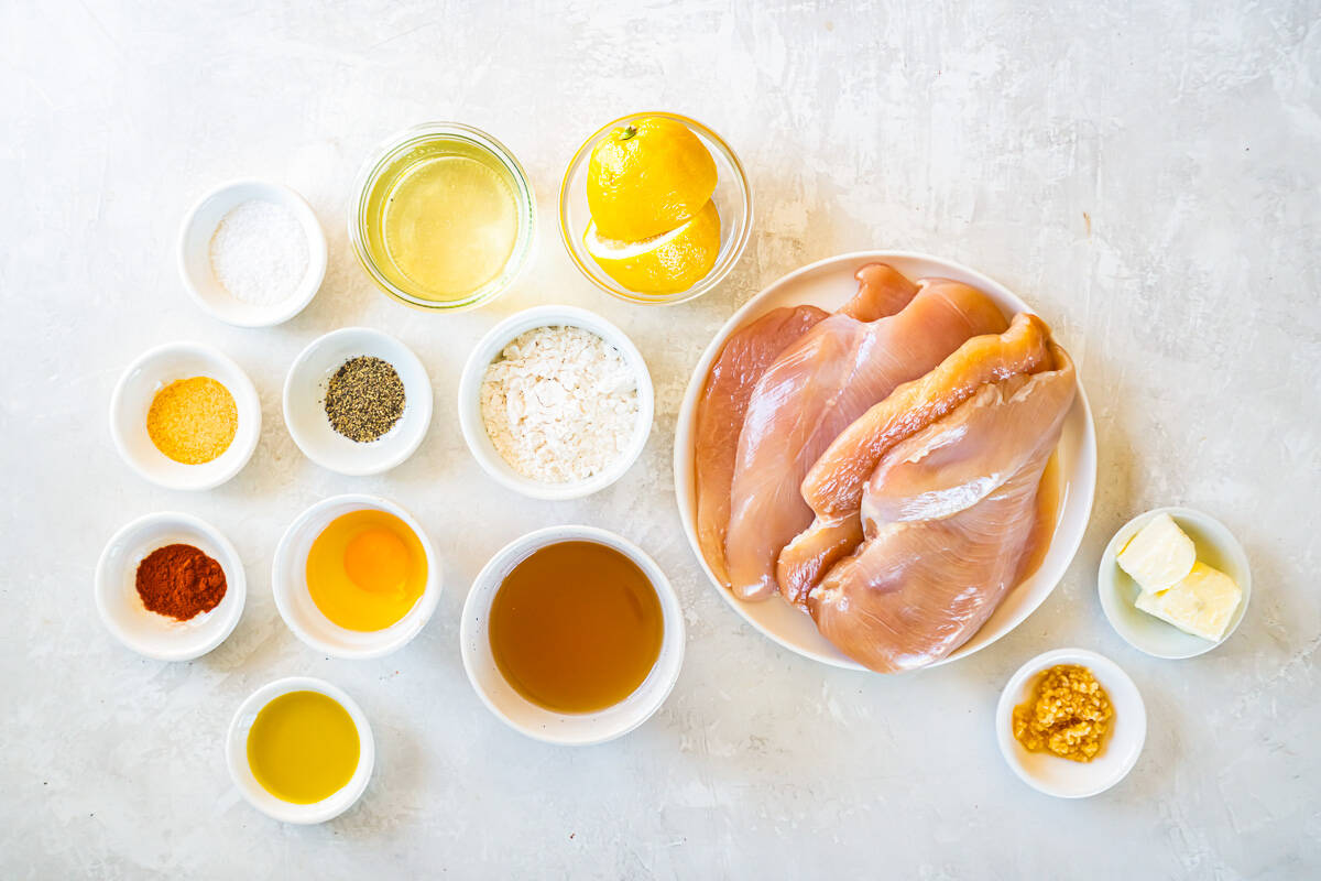 overhead view of ingredients for chicken francese in individual bowls.