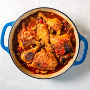 overhead view of chicken marengo in a blue pan.