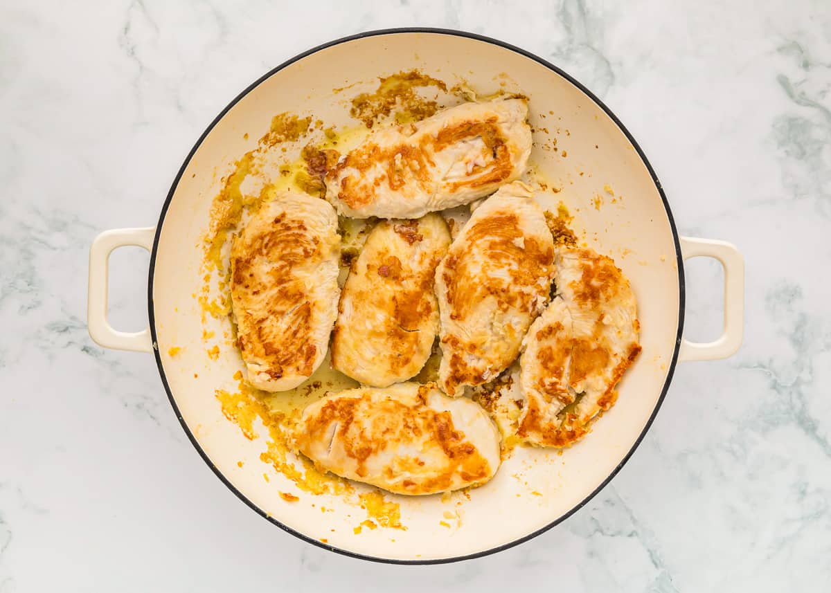 cooked chicken breasts in a pan.