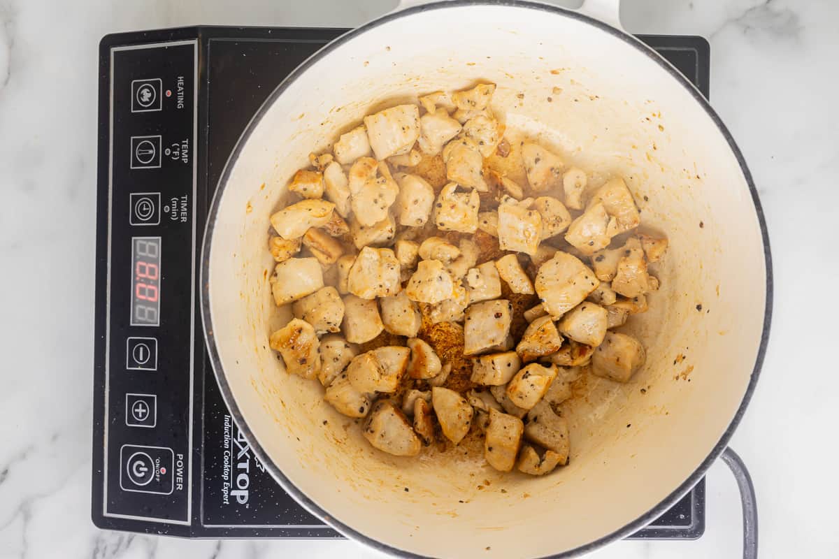 cooked chicken cubes in a pot.