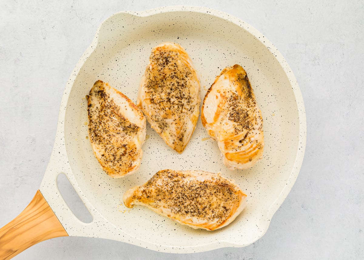 cooked chicken breasts in a white pan.