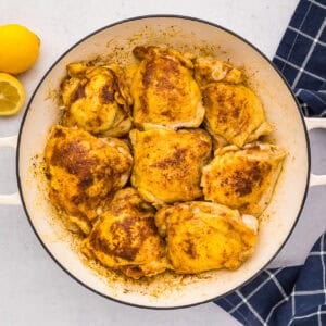 cooked chicken thighs in a pot.