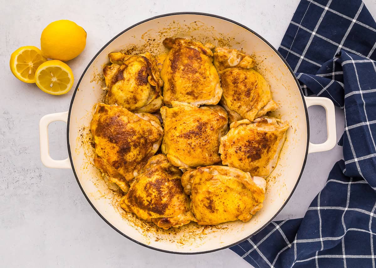 cooked chicken thighs in a pot.