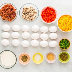 overhead view of ingredients for sheet pan eggs in individual bowls.