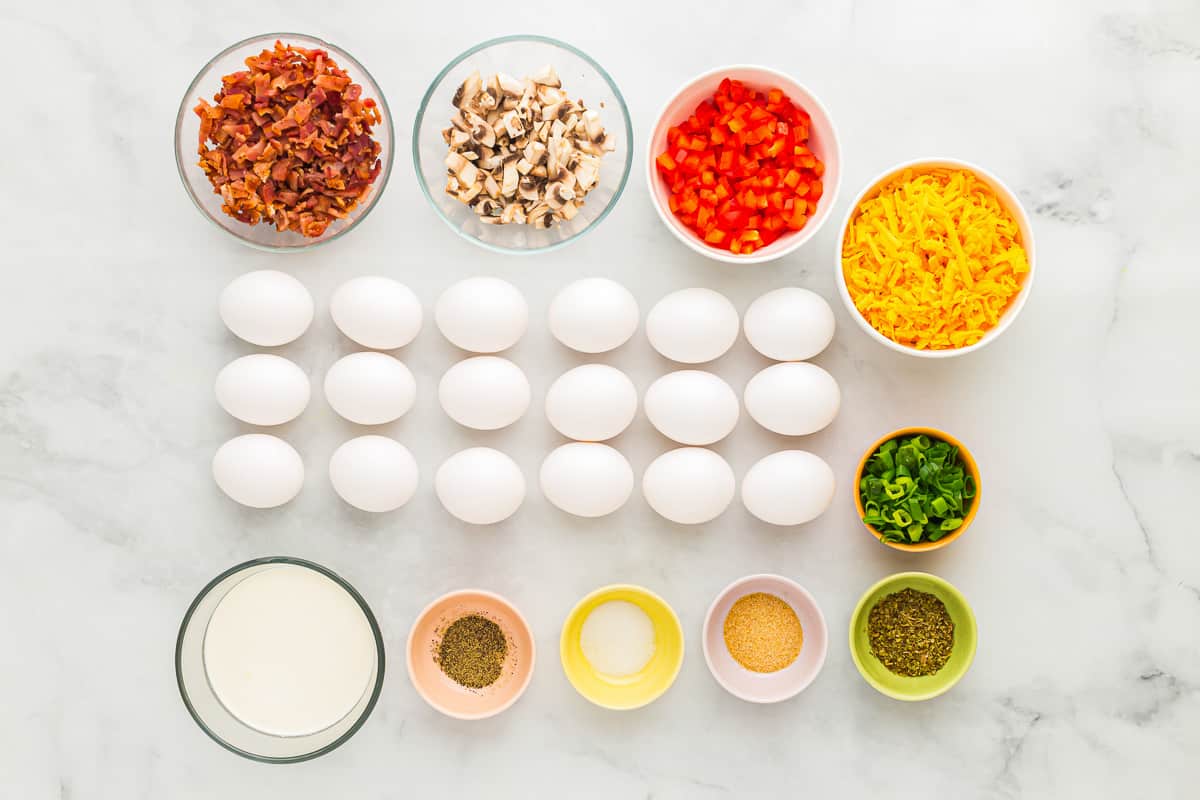 overhead view of ingredients for sheet pan eggs in individual bowls.