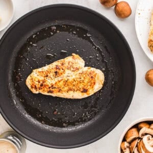 a cooked chicken breast in a skillet.