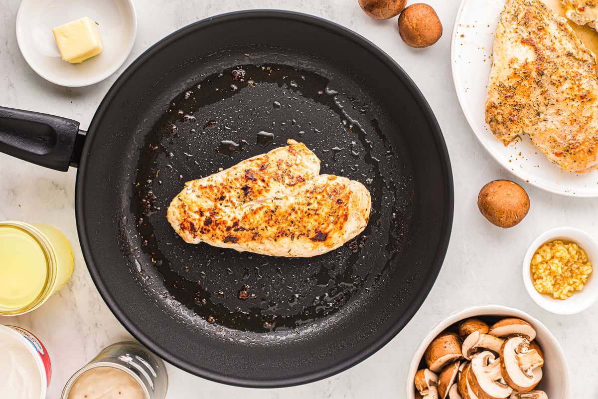 a cooked chicken breast in a skillet.