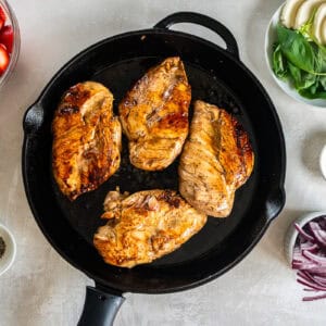 seared balsamic chicken breasts in a pan.