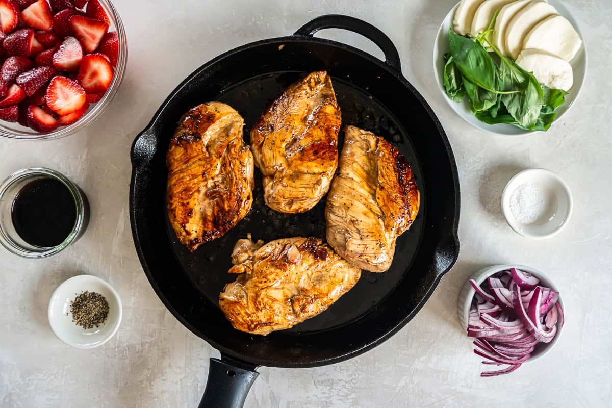 seared balsamic chicken breasts in a pan.